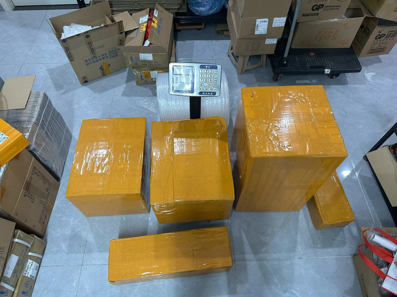 Sealed outbound parcels beside a parcel scale